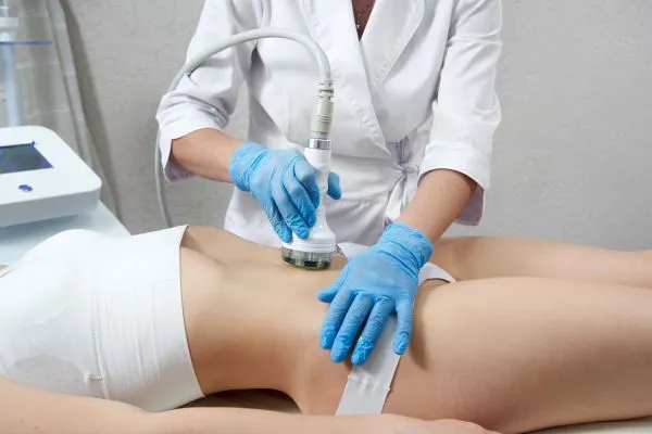 Lost the Weight but Not the Loose Skin? 2 woman having HIFU treatment on her stomach to combat loose skin Theale following weight loss